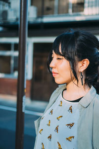 Young woman standing against blurred background