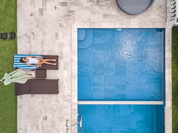 Aerial view of attractive woman near the pool at resort