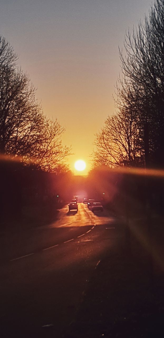 sunset, car, bare tree, orange color, road, transportation, tree, no people, silhouette, sun, land vehicle, sky, outdoors, nature, beauty in nature