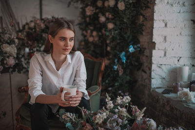 Portrait of young woman standing outdoors