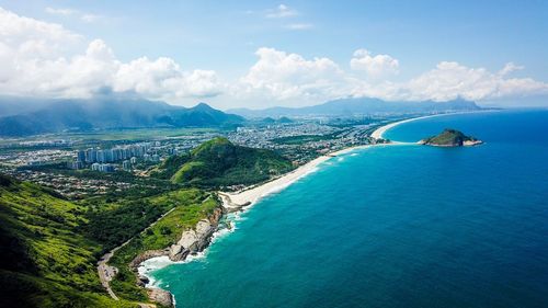 Scenic view of sea and mountains against sky