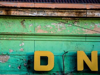Close-up of yellow wood against blue sky