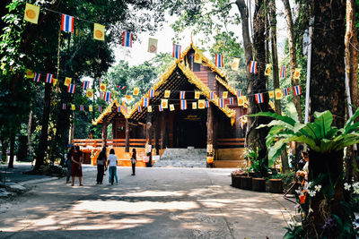 People on street amidst buildings in city