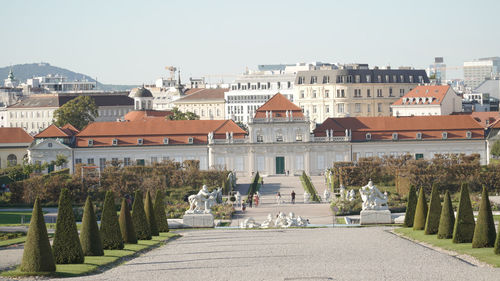 Buildings in city against clear sky