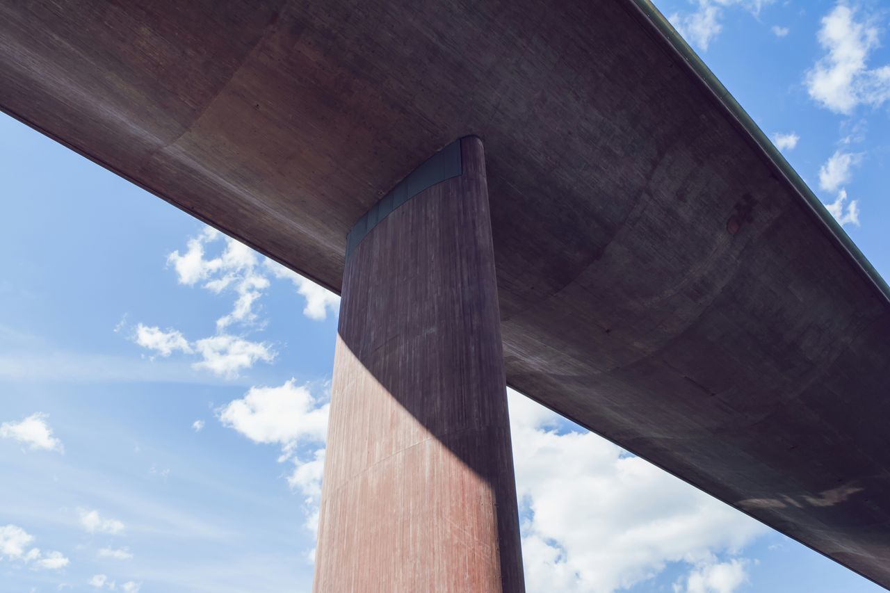 low angle view, built structure, sky, architecture, cloud - sky, wood - material, cloud, architectural column, column, day, old, building exterior, wood, no people, outdoors, blue, part of, wooden, cloudy, sunlight