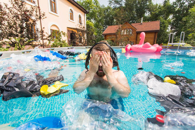 High angle view of man floating in swimming pool