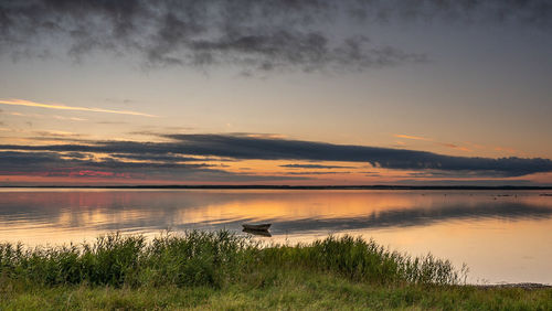 Scenic view of lake against sky during sunset