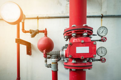 Close-up of red pipe against wall