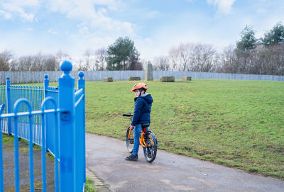 Rear view of man riding bicycle against sky