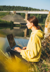 Side view of woman using mobile phone