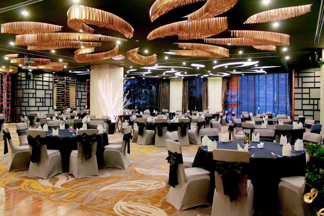 CHAIRS AND TABLES IN ILLUMINATED RESTAURANT