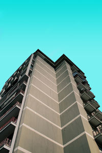 Low angle view of buildings against clear blue sky