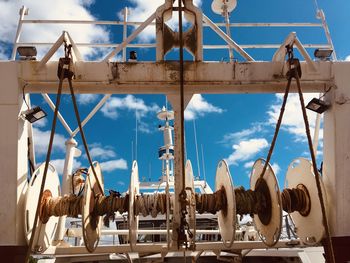 Low angle view of sailboats against blue sky
