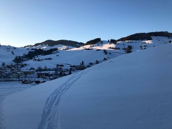 Scenic view of snow covered mountains against sky