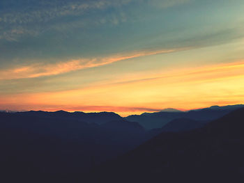 Scenic view of silhouette mountains against sky during sunset