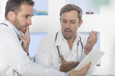 Two doctors with tablet discussing