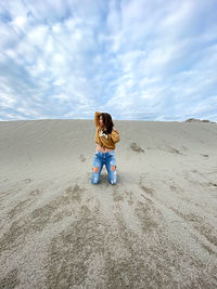 Rear view of women on sand dune