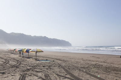 Scenic view of beach against clear sky