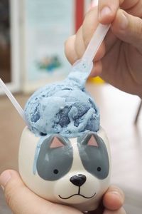 Scoop purple butterfly pea milk ice cream homemade in cute cat bowl