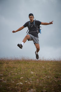 Man is running down gravel hill, checking his every step to avoid injury. athlete runs over terrain