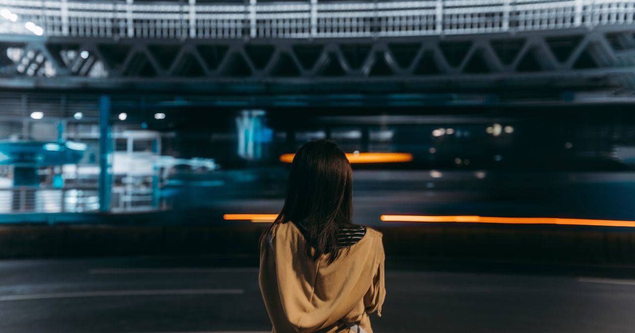 transportation, architecture, rear view, connection, bridge - man made structure, built structure, one person, real people, bridge, illuminated, motion, women, lifestyles, standing, adult, blurred motion, hair, hairstyle, city, outdoors