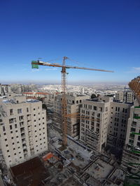 Aerial view of buildings against clear blue sky