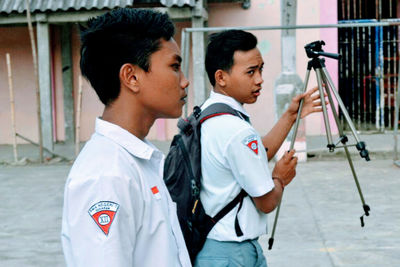 Side view of man holding camera