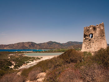 Scenic view of beach against clear blue sky