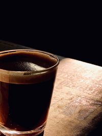 Close-up of coffee on table against black background