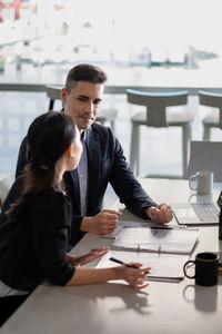 Business colleagues talking at office