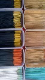 Directly above shot of incenses in container at market stall