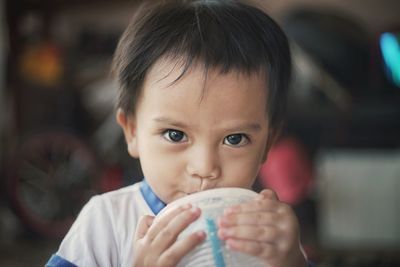 Portrait of cute boy drinking coffee