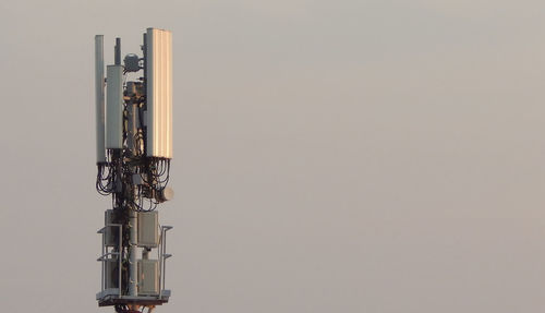 Low angle view of communications tower against sky