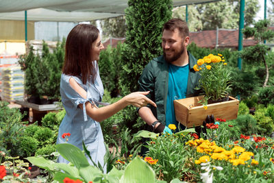 Midsection of woman holding vegetables for sale