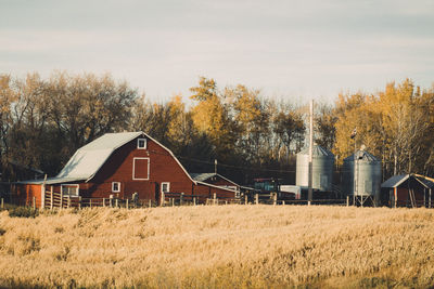 Barn on field against sky