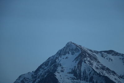 Scenic view of snowcapped mountains against clear blue sky