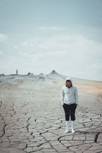 Full length of man standing on desert against sky