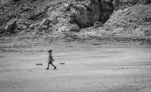 Full length of woman standing on rock