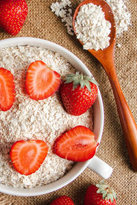 High angle view of food on table. oatmeal ans strawberries 