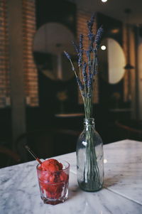 Close-up of glass jar with glass of icecream on table