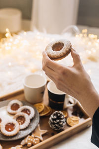 Close-up of hand holding dessert on table