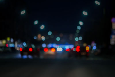 Defocused image of illuminated city at night