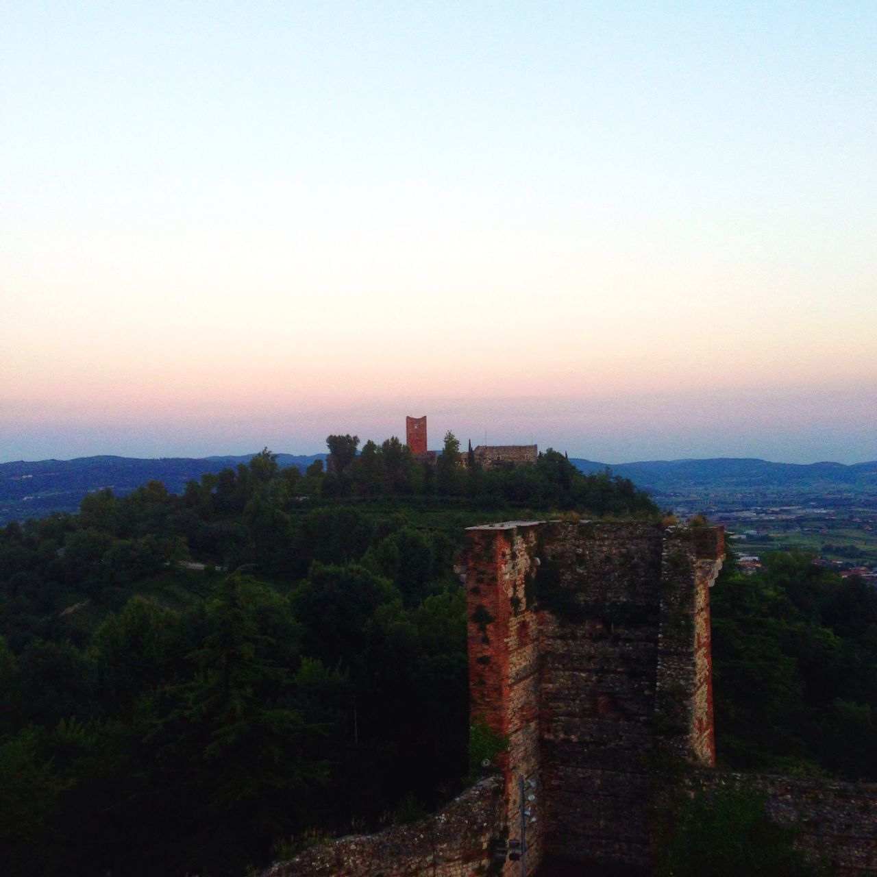 architecture, built structure, building exterior, sunset, clear sky, copy space, tree, history, famous place, travel destinations, sky, tranquility, scenics, landscape, tourism, nature, travel, high angle view, ancient, outdoors