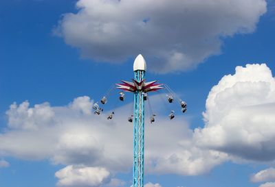 Low angle view of amusement park ride against sky