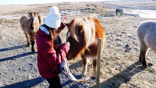Rear view of woman standing on field