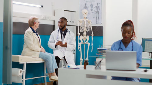 Female doctor examining x-ray at clinic