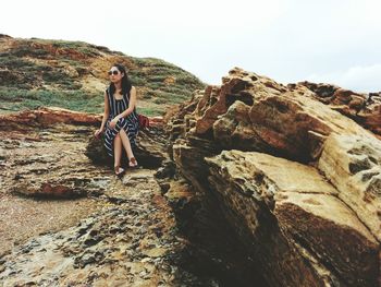 Full length of woman standing on rock