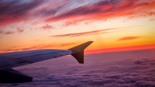 Cropped image of airplane flying over cloudscape