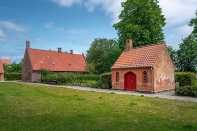 Houses on field against sky