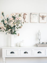 White flowers in vase on table at home